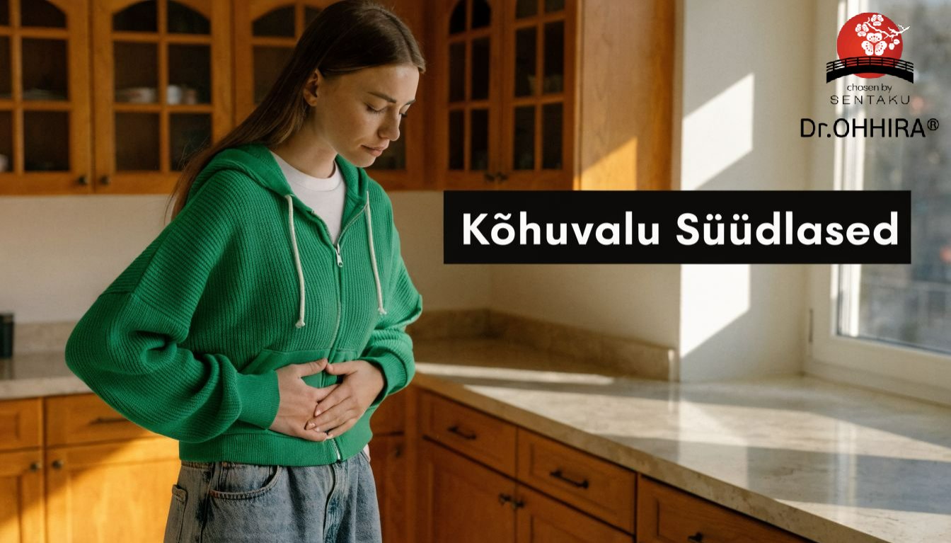 Noor naine rohelises kapuutsiga särgis hoiab kõhtu, tundes ebamugavust või valu. Pildil on tekst 'Kõhuvalu Süüdlased'.